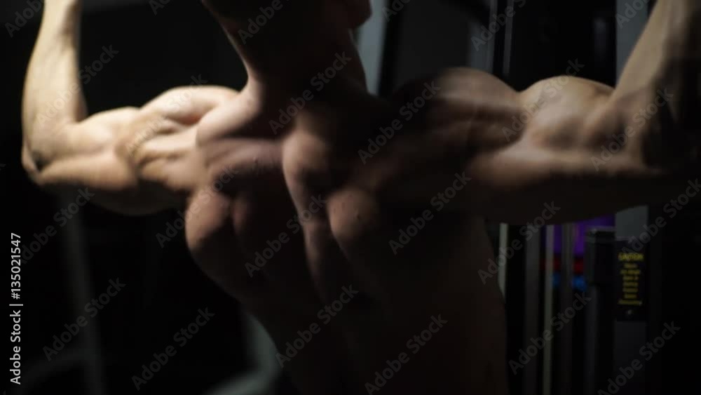 Muscular bodybuilder handsome men doing exercises in gym naked torso