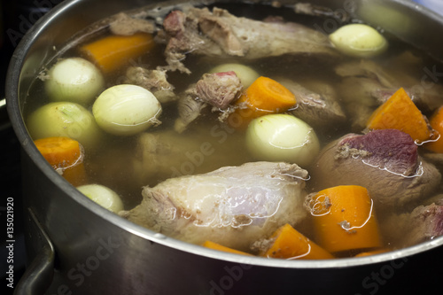 Cooking beef broth with onions and carrots