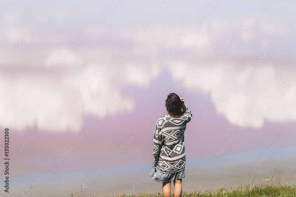 Woman watching at clouds reflection in lake surface. Beautiful s Woman watching at clouds reflection in lake surface. Beautiful s