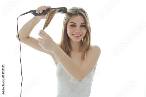 Woman enjoying hair iron 