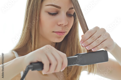 Woman enjoying hair iron 