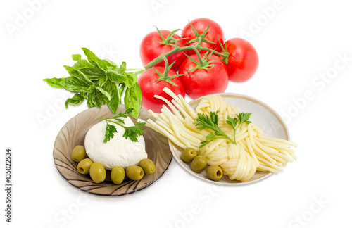 Two kinds of mozzarella cheese, olives, tomatoes and potherb