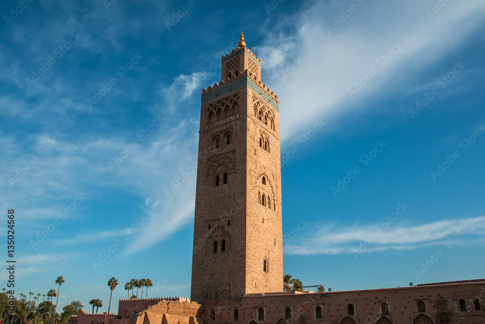 Koutoubia Mosque and palm trees in Marrakech at evening