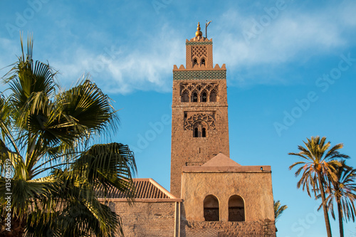 Koutoubia Mosque and palm trees in Marrakech at evening