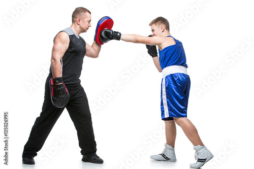 Young boxer working out with coach