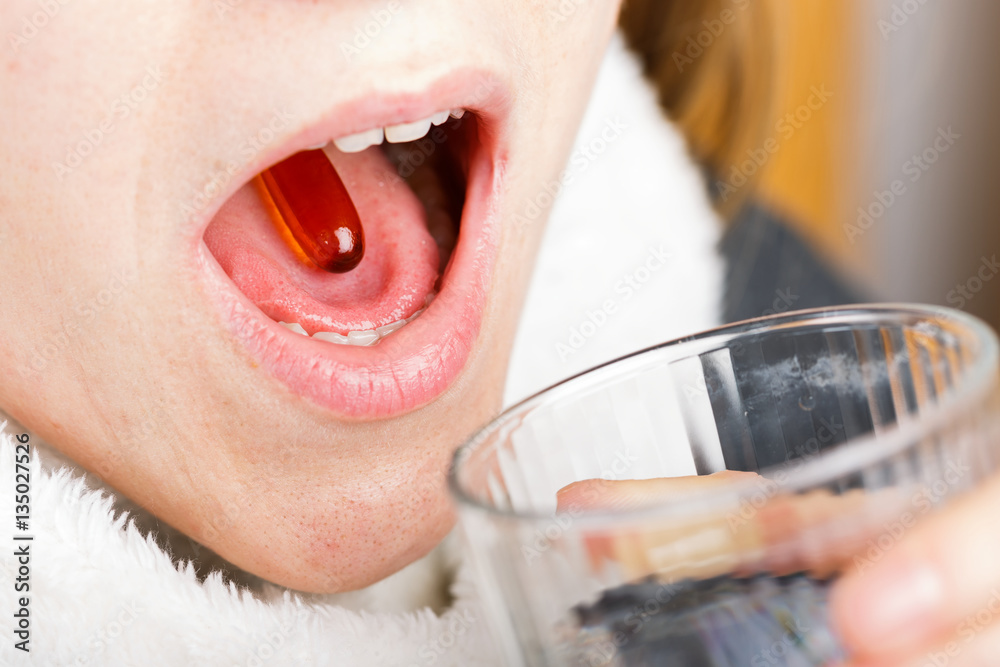 Fish oil capsule in mouth