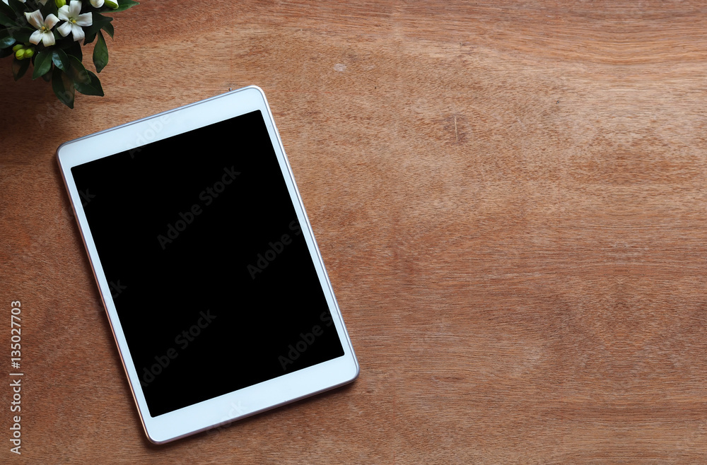 Empty tablet on wood work desk, soft focus vintage color tone, business and education background Empty tablet on wood work desk, soft focus vintage color tone, business and education background
