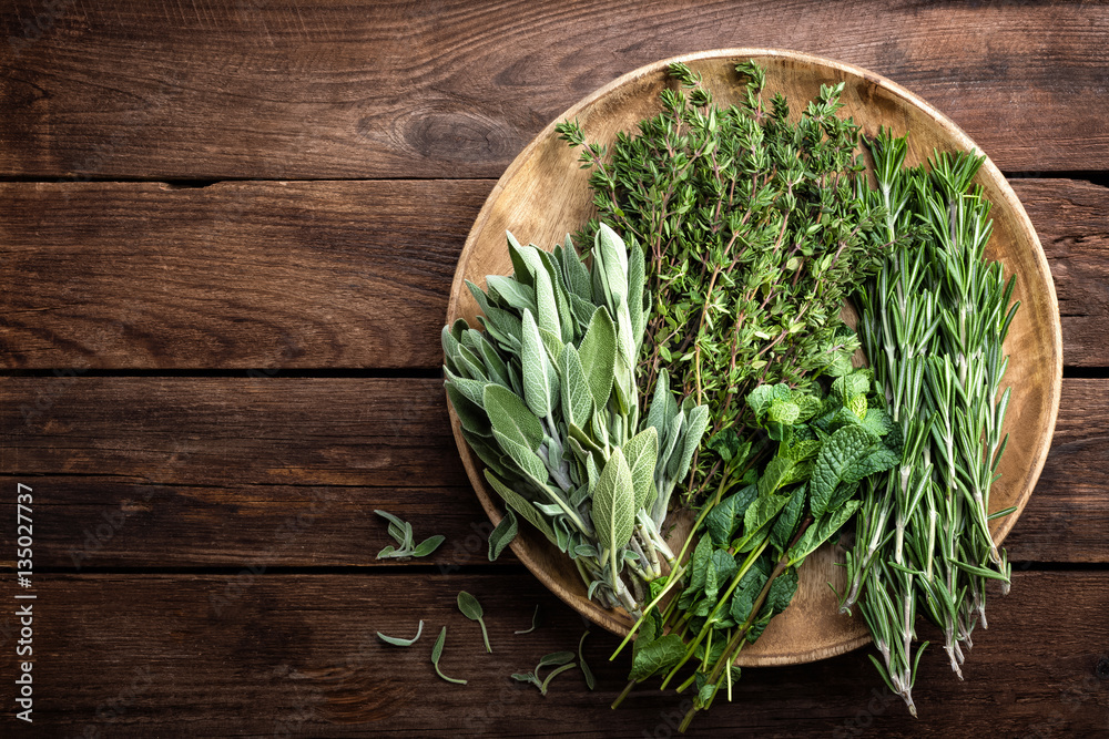 various fresh herbs, rosemary, thyme, mint and sage on wooden background - obrazy, fototapety, plakaty 