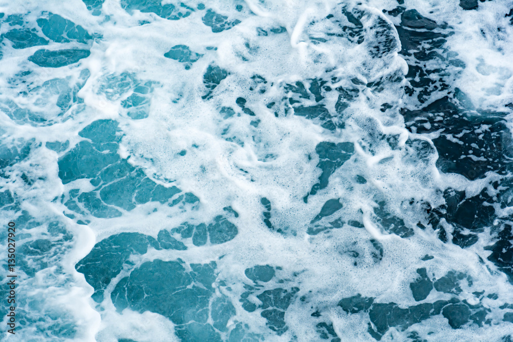 Blue sea and a moving reflection of sunlight