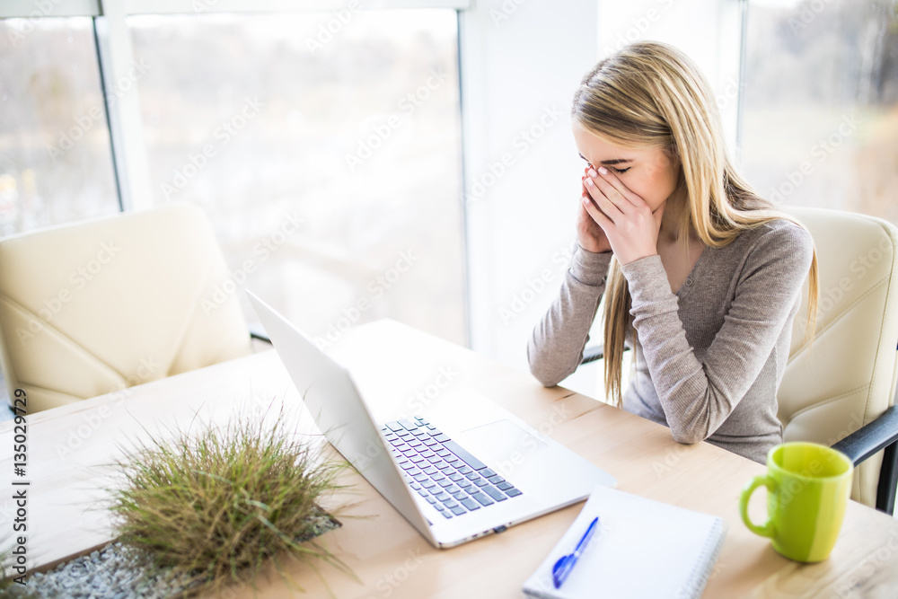 Tired and sad business woman at work place Tired and sad business woman at work place