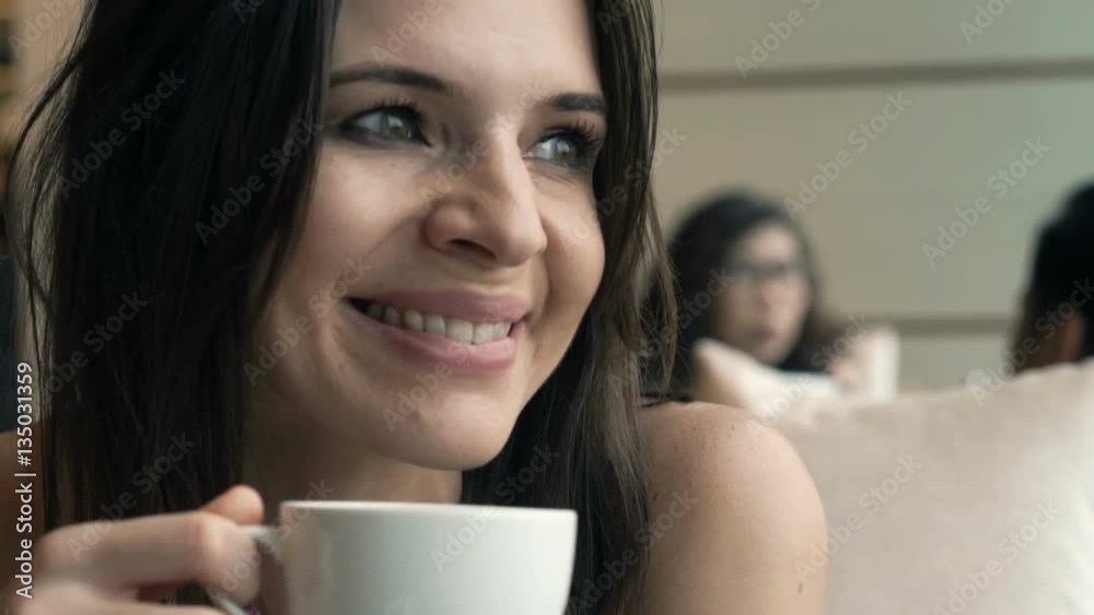Pretty, happy woman drinking coffee sitting in cafe
Pretty, happy woman drinking coffee sitting in cafe
