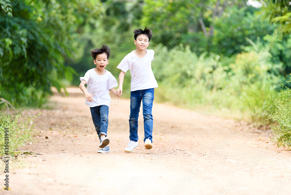 Two boy run in the park Two boy run in the park