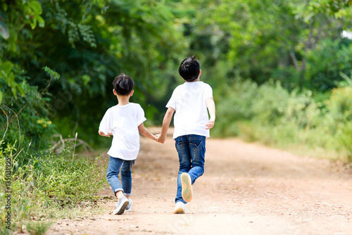 Two boy run in the park