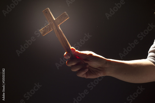 Worship - woman holding cross with qlow