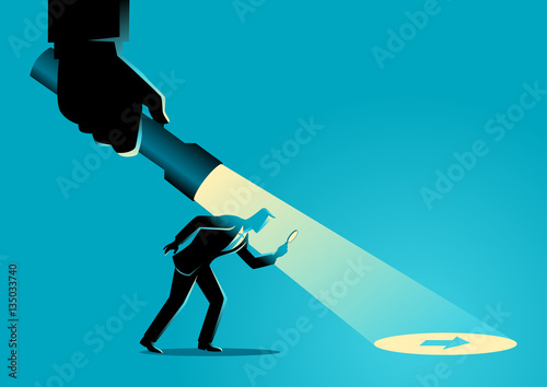 Businessman being guided by a hand holding a flashlight