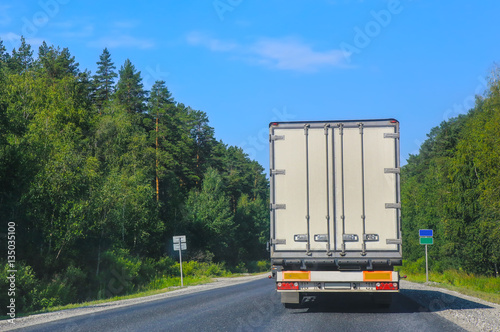 white truck transports freight