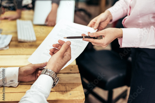 Person giving pen to paper.