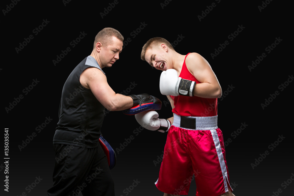 Young boxer working out with coach