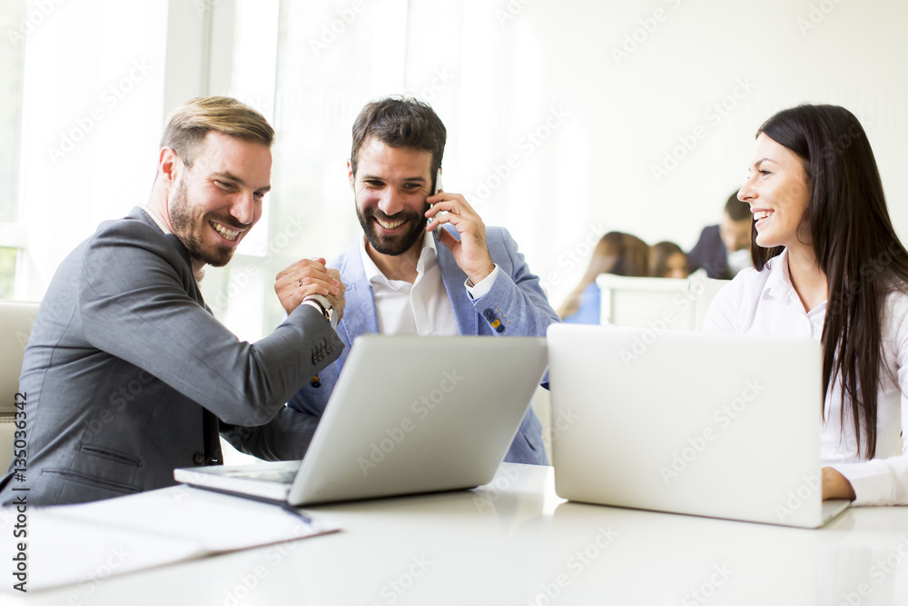 Young successful managers discussing new business project Young successful managers discussing new business project