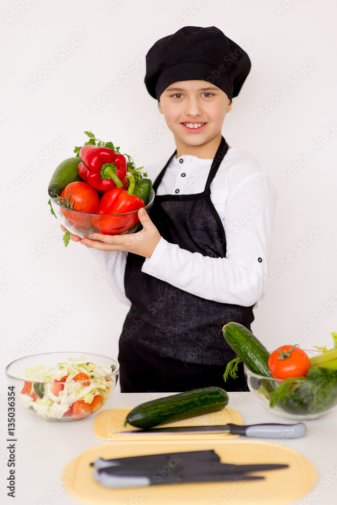 young boy holding a plate with vegetables isolate young boy holding a plate with vegetables isolate