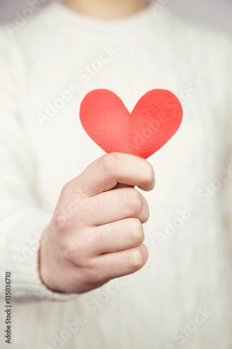 woman holding love heart object in hand for valentine day