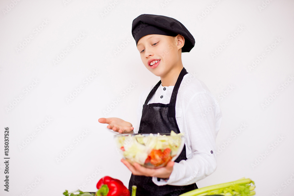 young chef going to prepare a salad isolated young chef going to prepare a salad isolated