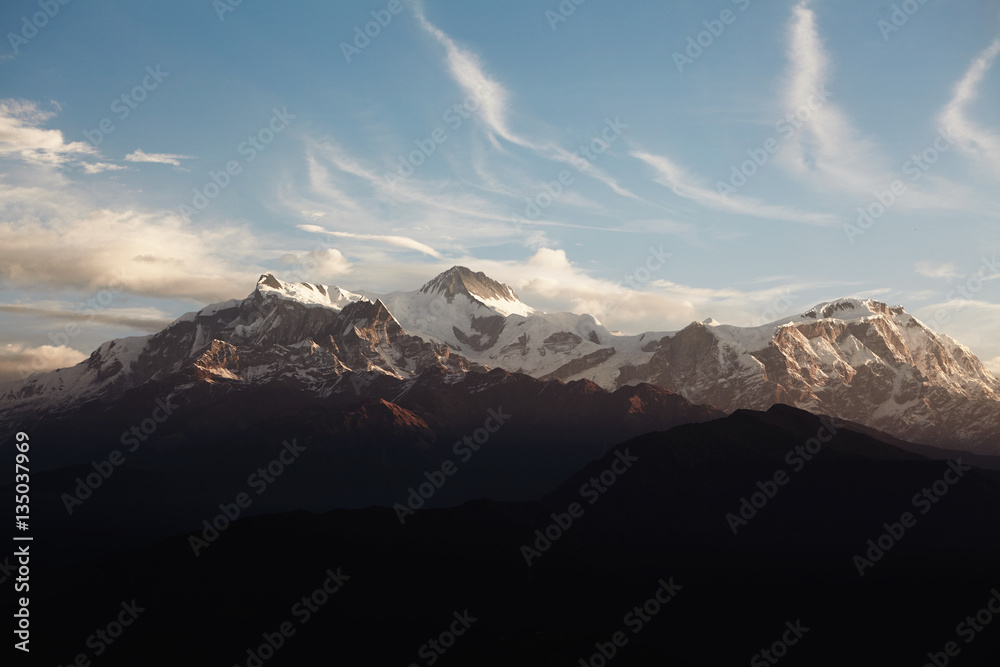 Amazing cloudy sunrise in the Himalayas with snow on peaks. Calm and peaceful shot of beautiful high mountains, perfect destination for mountaineer. Hiking, climbing and mountaineering concept