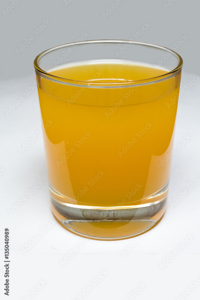 Glass with yellow liquid Glass with yellow liquid