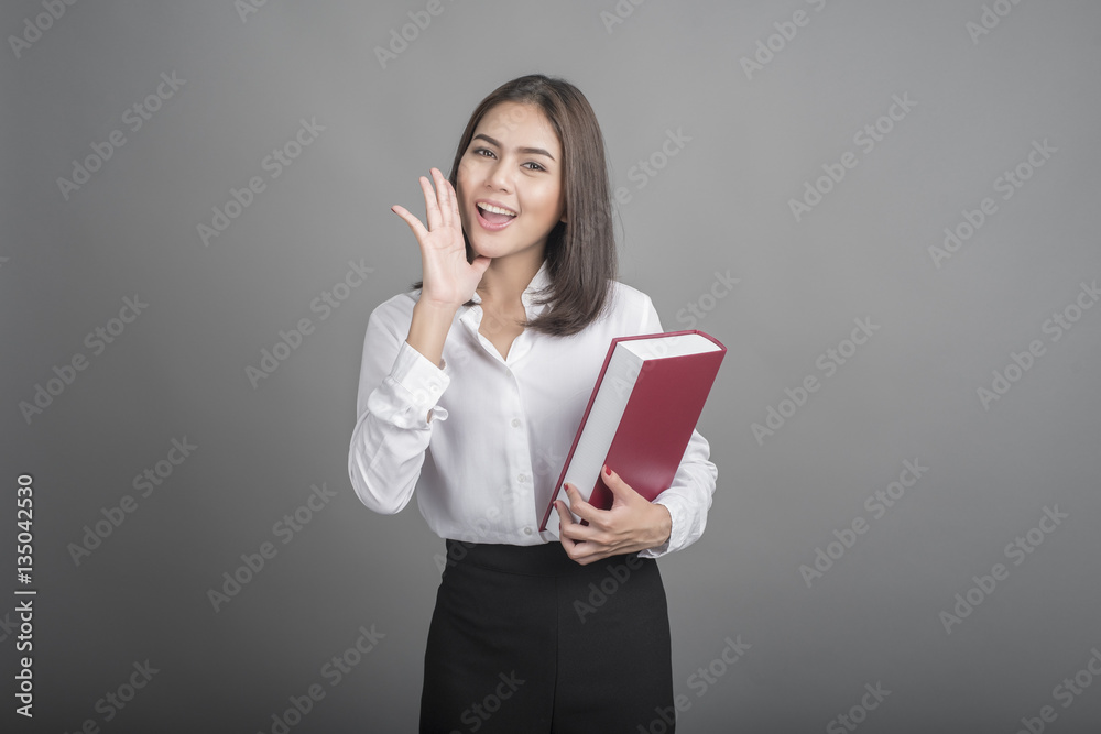 Beautiful teacher Woman holding book on grey background Beautiful teacher Woman holding book on grey background