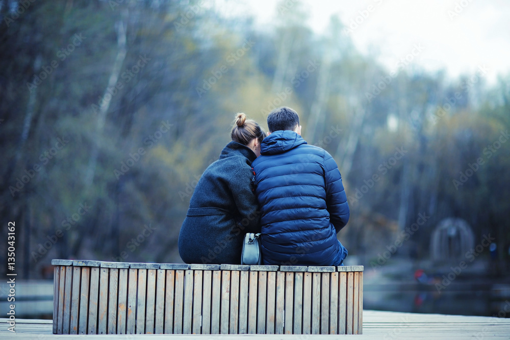 Fototapeta premium young couple at the park in winter view from the back