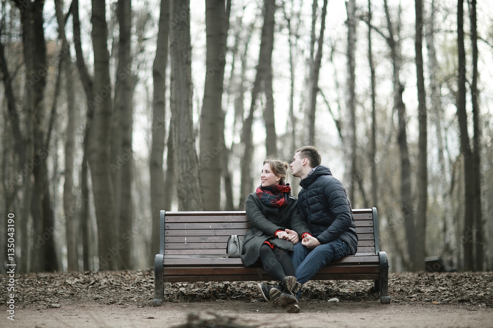 lovers resting in a city park in the winter lovers resting in a city park in the winter