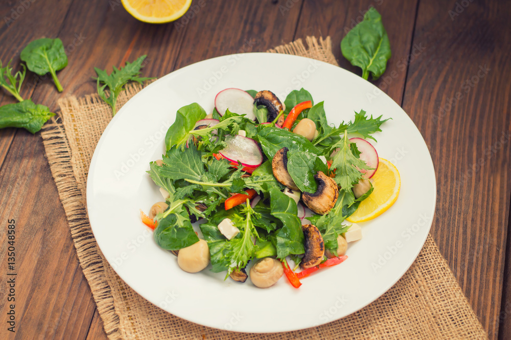 Fresh spring salad with radish, Mizuno, mushrooms grilled, Adygei cheese, spinach, bell pepper, lemon, corn. Wooden background Fresh spring salad with radish, Mizuno, mushrooms grilled, Adygei cheese, spinach, bell pepper, lemon, corn. Wooden background