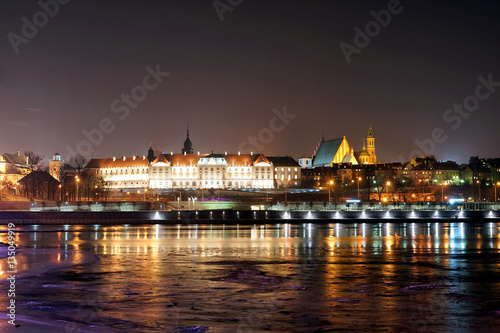 Night view of the Royal Castle and Vistula river in Warsaw, Poland