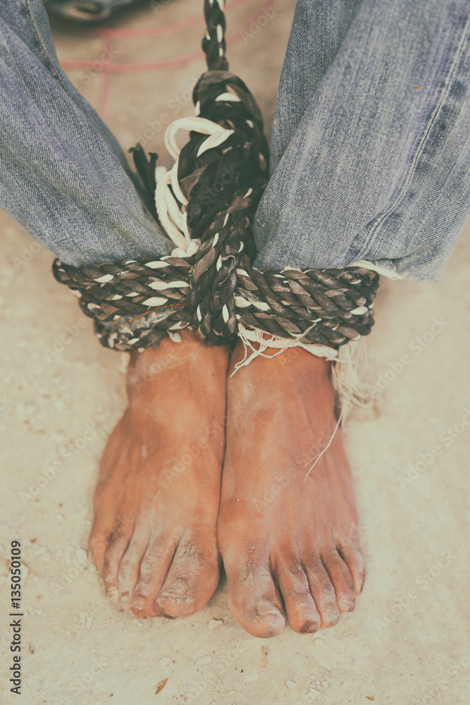 hopeless man feet tied together with rope