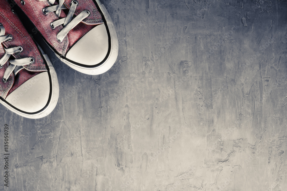 Two red sneaker on clean concrete background Two red sneaker on clean concrete background