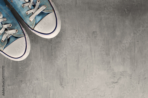 Two blue sneaker on  clean concrete background