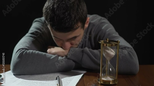 Doubtful young man uncertain about signing document, starting risky business