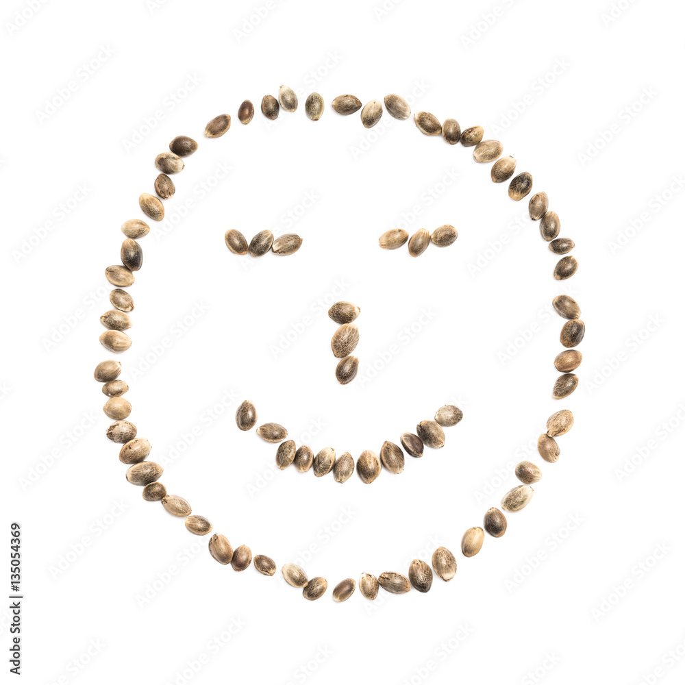 A smiley face made with hemp seeds on white background A smiley face made with hemp seeds on white background