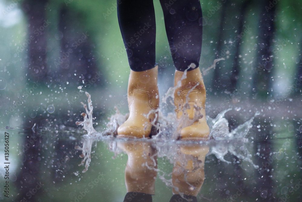 feet in rubber boots rain puddle city Stock Photo | Adobe Stock
