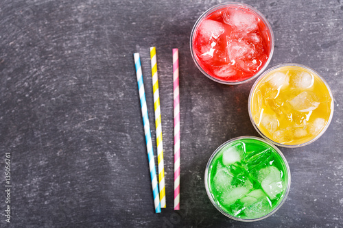 colorful cold drinks in plastic cups