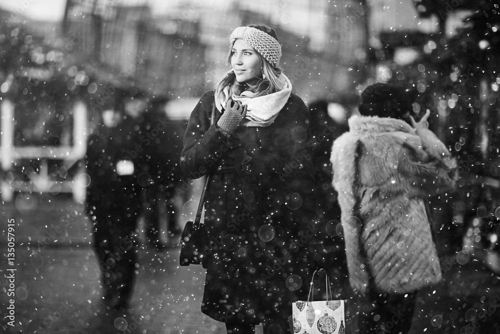 girl on a winter walk in the city, snow, outside. Winter street in the city.