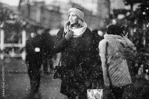 girl on a winter walk in the city, snow, outside. Winter street in the city.