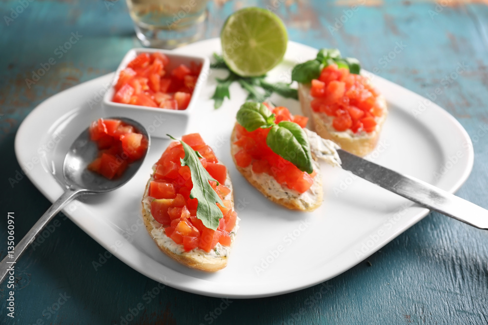 Plate with traditional Italian bruschetta on table