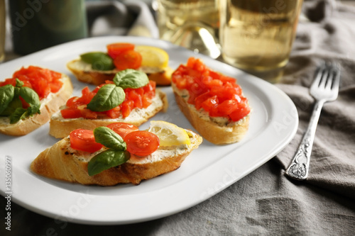 Delicious toast with tomatoes on plate