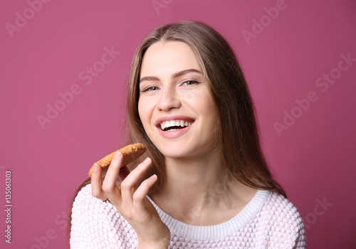 Young woman with cookie on ...