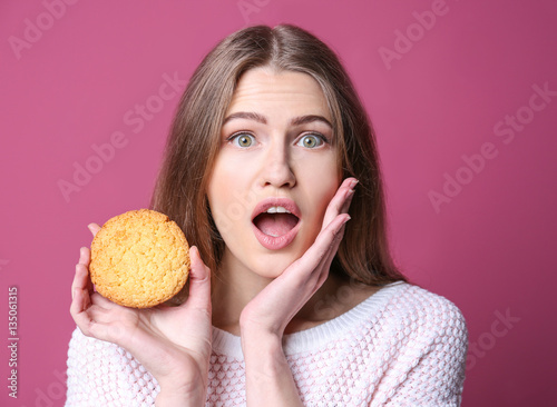 Young woman with cookie on ...