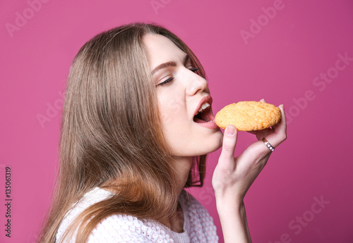 Young woman with cookie on ...