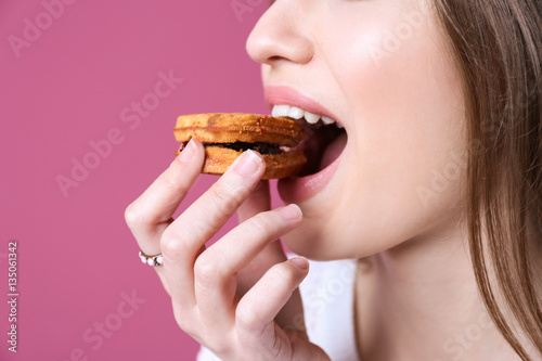 Young woman with cookie on ...