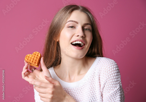 Young woman with cookie on ...