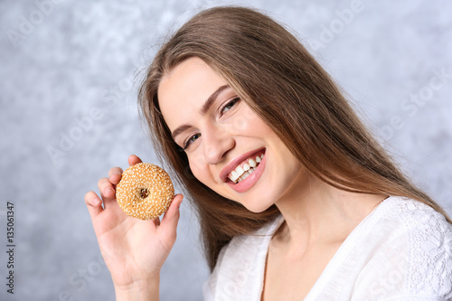 Young woman with cookie on ...